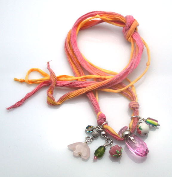 aromatherapy necklace with vintage beads, Mother Bear fetish and a faceted pink mini perfume bottle